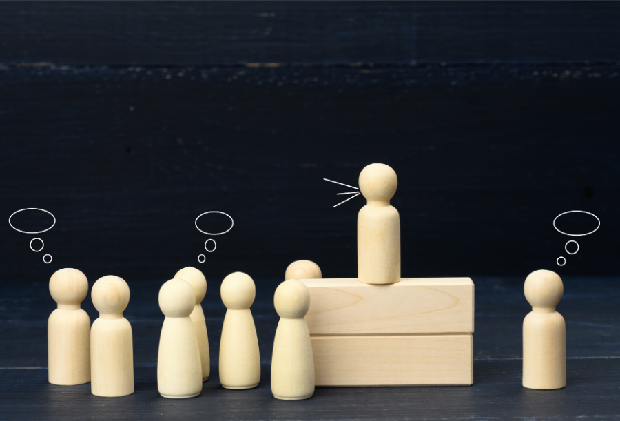 Wooden people with leader communicating